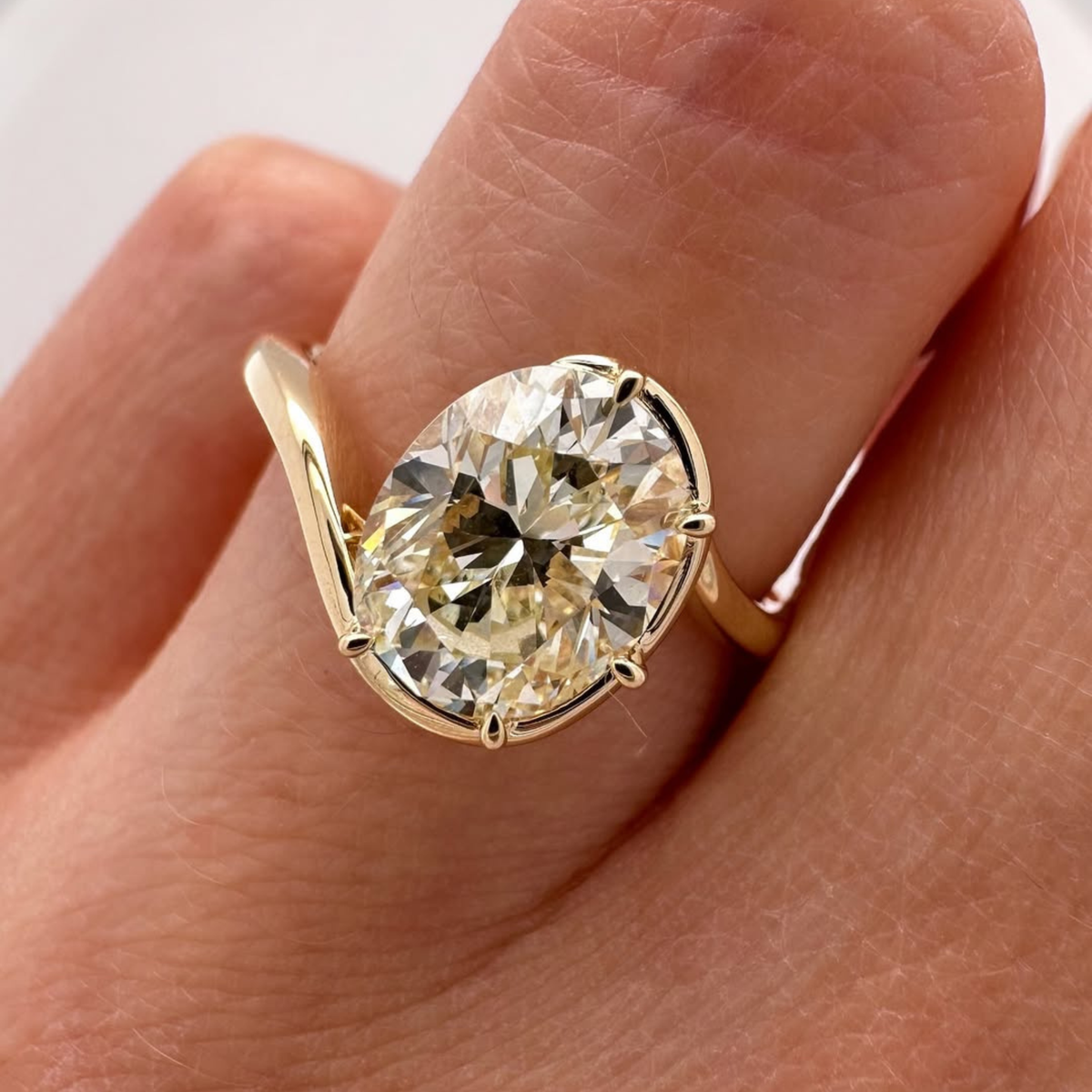 half bezel oval cut lab diamond bypass solitaire ring